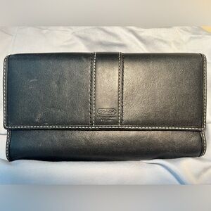 Coach black leather wallet with purple leather inside.